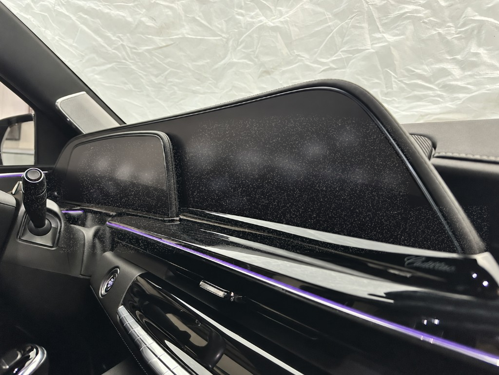 Cadillac dashboard and screen with light dust, before Ne10 Interior Detailer